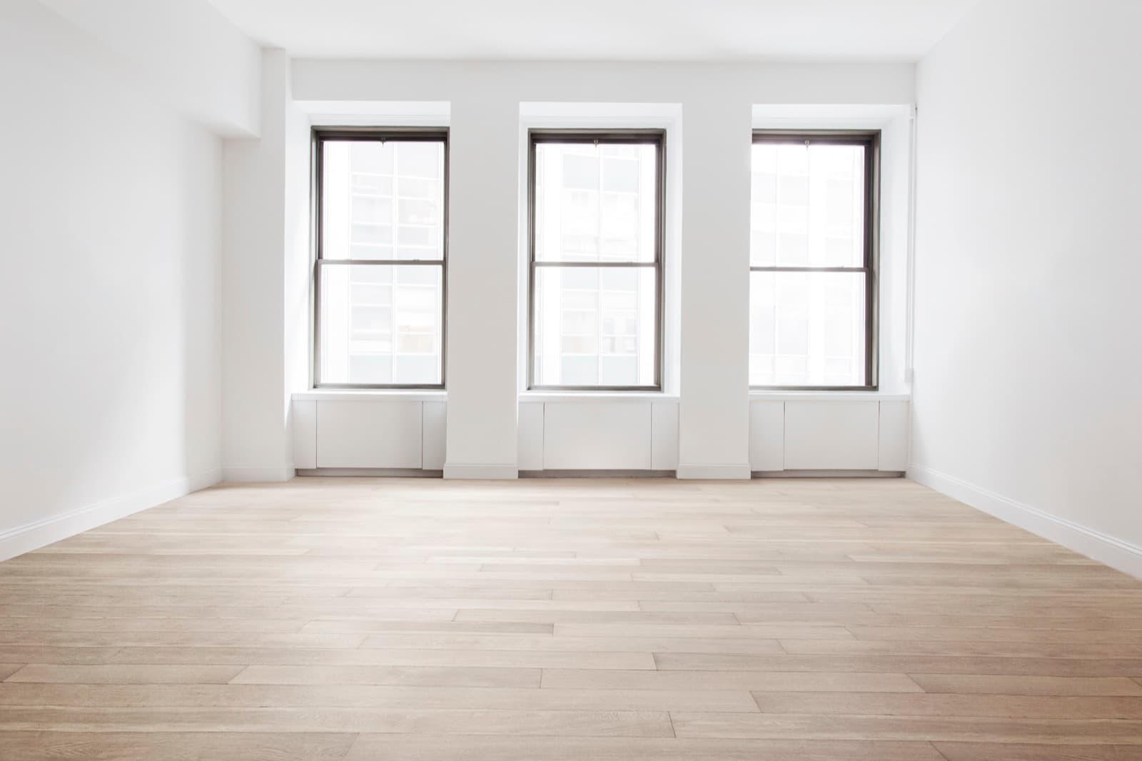 Bright apartment interior with new light wood-look flooring