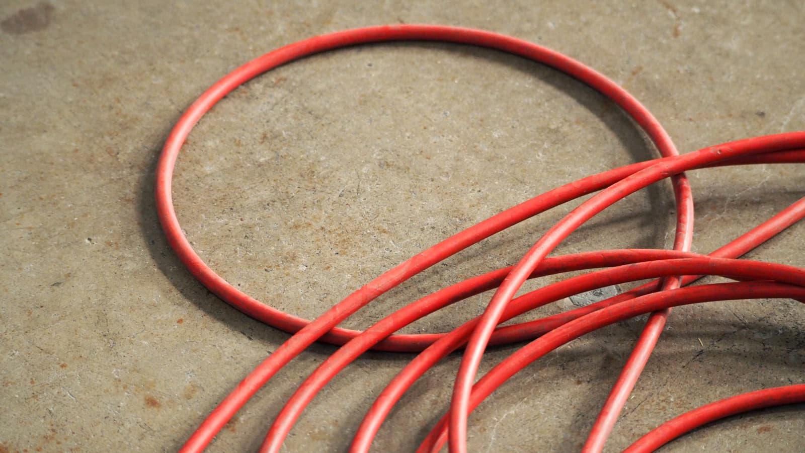 High-pressure jetting hoses coiled on a concrete surface
