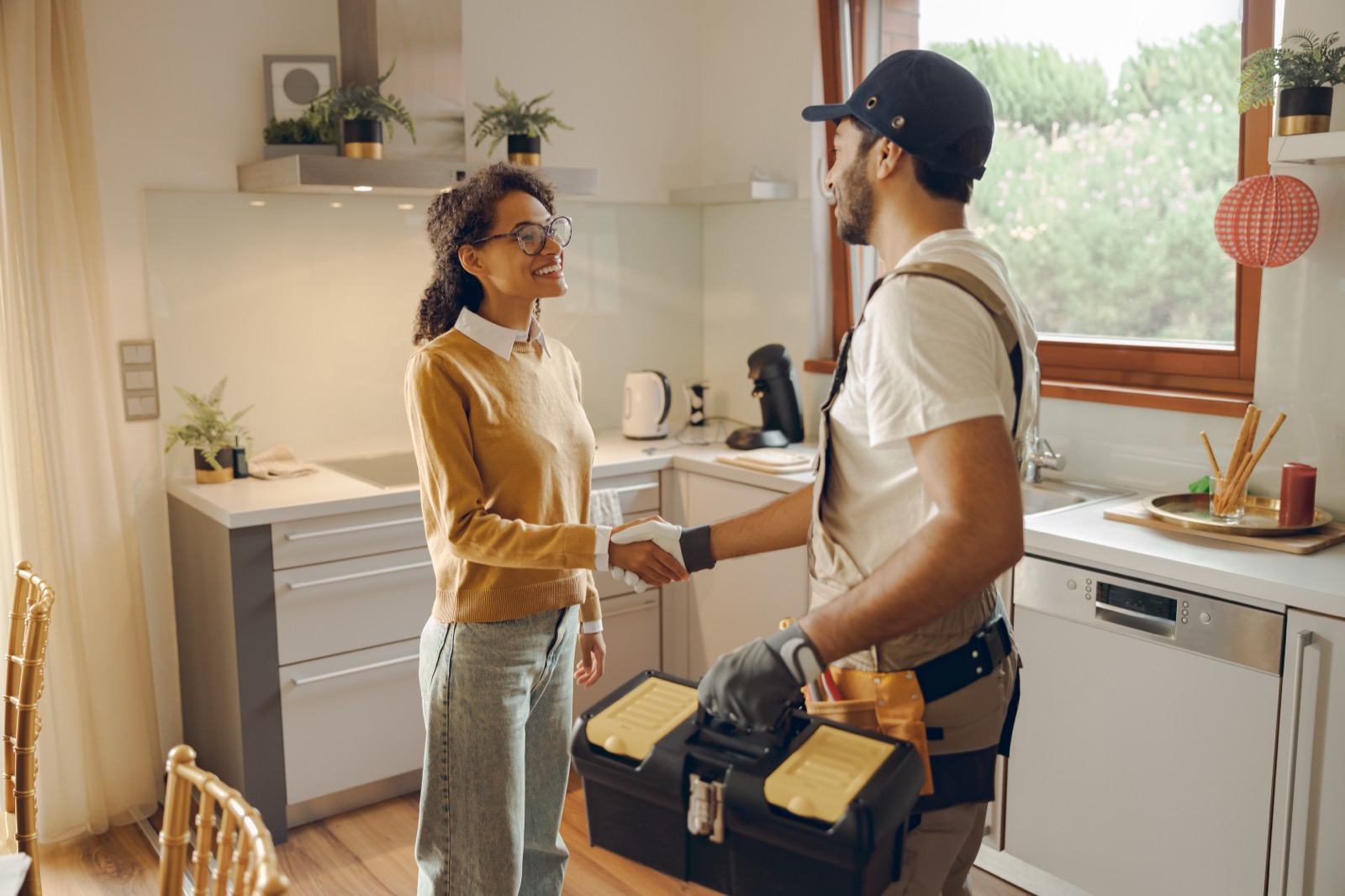 Homeowner welcoming a Dallas Plumber technician in for a scheduled repair